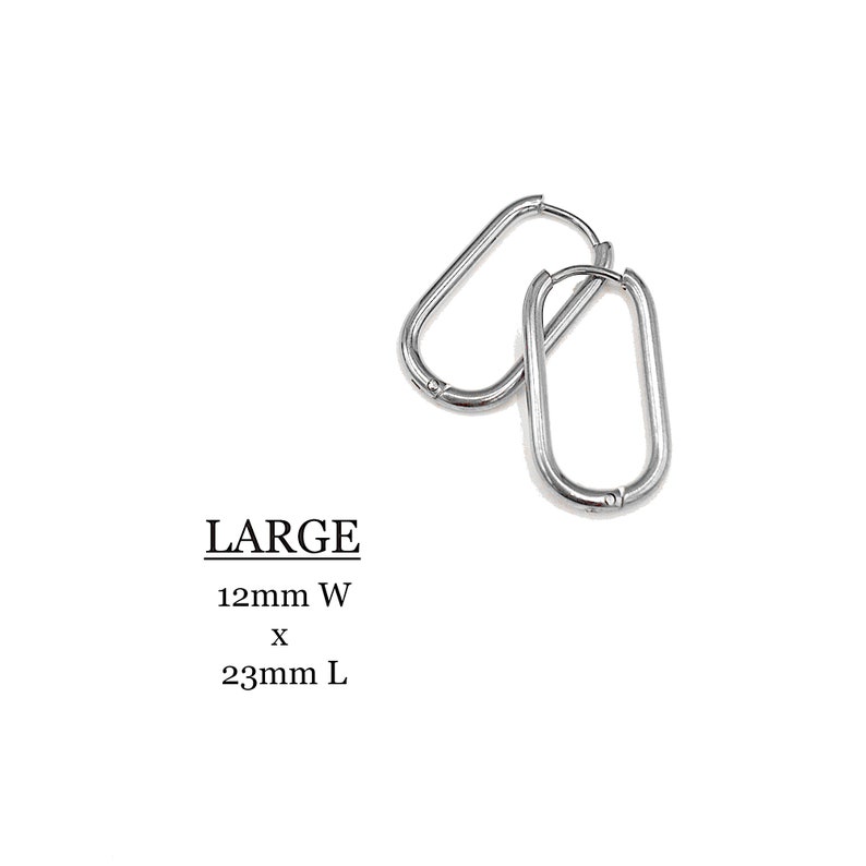 May include: A pair of large silver hoop earrings. The earrings are oval shaped and measure 12mm wide by 23mm long. LARGE 12mm W x 23mm L