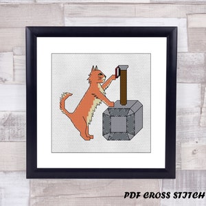 May include: A cross stitch pattern featuring a red cat holding a silver and gray hammer. The cat is looking at the hammer and has a determined expression. The hammer is a stylized version of Thor's hammer, Mjolnir.