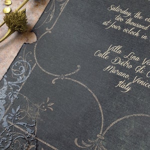 May include: A black invitation with gold lettering. The invitation is for a wedding in Venice, Italy. The text reads "Saturday, the eleventh of June, two thousand twenty-three at four o'clock in the afternoon. Villa Lina Venezia, Calle Dietro Gli Orti, Murano, Venice, Italy."