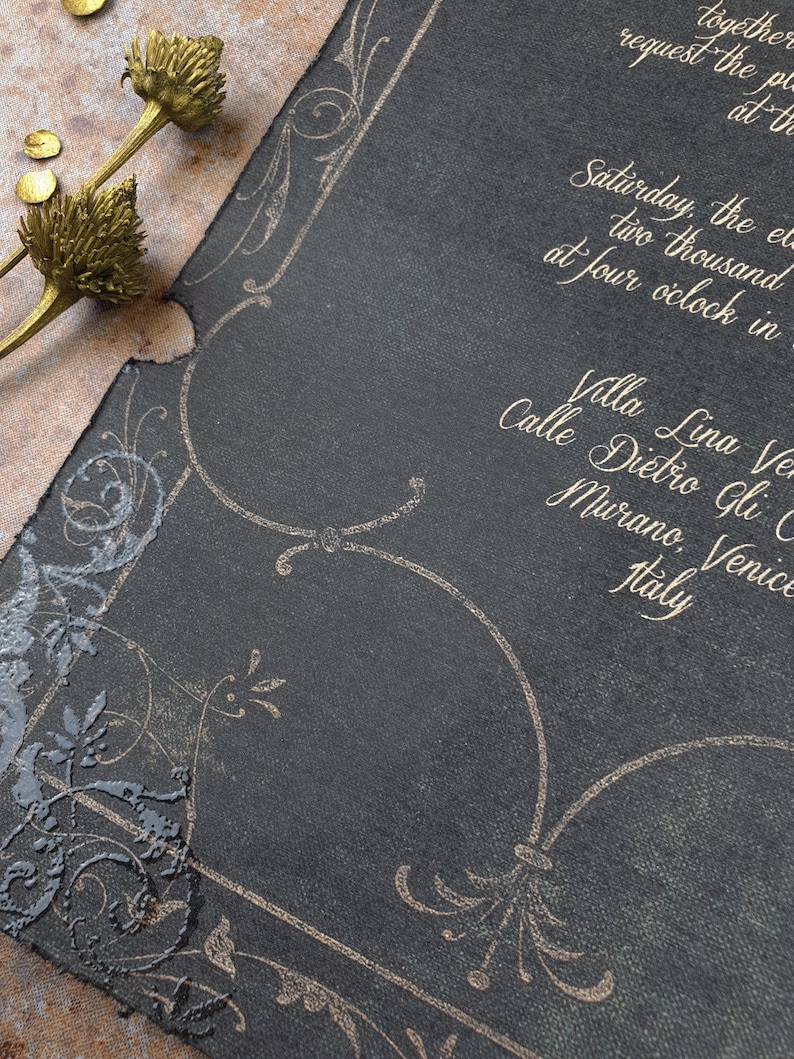 May include: A black invitation with gold lettering. The invitation is for a wedding in Venice, Italy. The text reads "Saturday, the eleventh of June, two thousand twenty-three at four o'clock in the afternoon. Villa Lina Venezia, Calle Dietro Gli Orti, Murano, Venice, Italy."