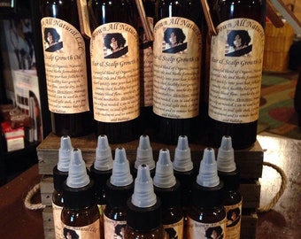May include: A collection of small brown glass bottles with dropper tops, filled with a golden liquid. Each bottle has a label with a brown background and a picture of a woman with a crown. The label reads "Brown All Natural LLC Hair & Scalp Growth Oil".