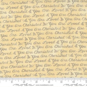 May include: A fabric with a repeating pattern of the phrases "You Are Cherished" and "You Are Loved" in a cursive font. The text is in a dark gray color, set against a light yellow background. A ruler is at the bottom.