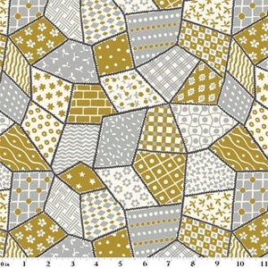 May include: A patchwork fabric design featuring irregular geometric shapes in shades of gold, gray, and cream. Each patch displays a unique pattern, including floral, dotted, and geometric motifs. The patches are outlined with dark gray stitching.