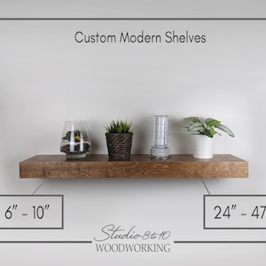 May include: A custom modern wooden shelf with plants and decorative items. The shelf is a warm brown color and is mounted on a white wall. The shelf dimensions are 6"-10" and 24"-47". The text "Custom Modern Shelves" and "Studio 8to10 WOODWORKING" are also visible.