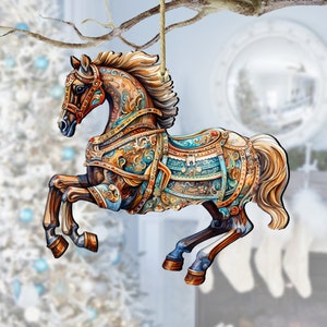 May include: A wooden carousel horse ornament with intricate details. The horse is painted in shades of brown, gold, and blue with a floral design. It has a raised tail and mane and is ready to hang on a Christmas tree.