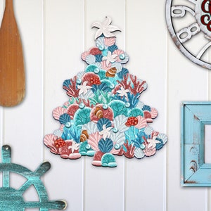 May include: A Christmas tree ornament shaped like a Christmas tree made of seashells, coral, and starfish in shades of pink, blue, and green.