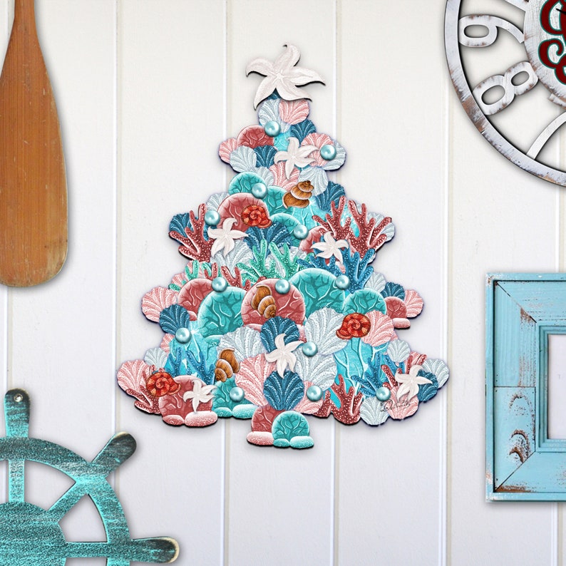 May include: A Christmas tree ornament shaped like a Christmas tree made of seashells, coral, and starfish in shades of pink, blue, and green.