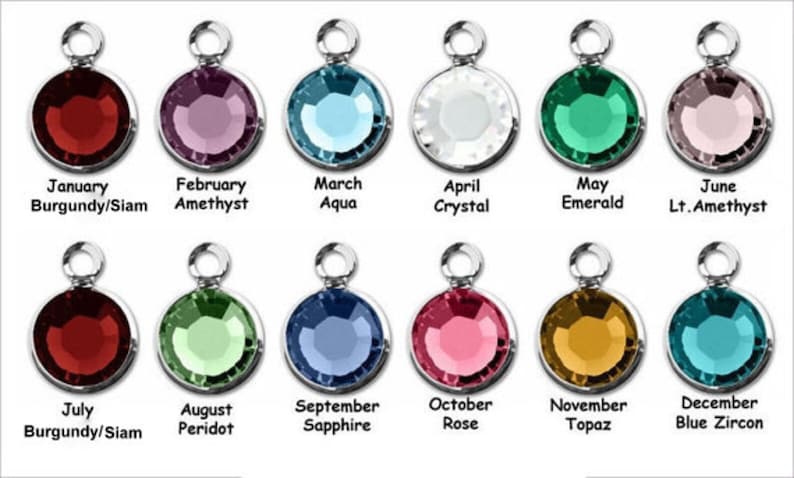 May include: Twelve round crystal charms, each representing a different birthstone. The charms are silver-toned and feature a loop for attaching to jewelry. The birthstones are: January - Burgundy/Siam, February - Amethyst, March - Aqua, April - Crystal, May - Emerald, June - Light Amethyst, July - Burgundy/Siam, August - Peridot, September - Sapphire, October - Rose, November - Topaz, December - Blue Zircon.