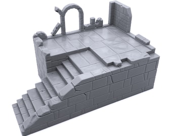May include: A gray, stone-like miniature building with a set of stairs leading up to a platform with a broken archway. The platform has a textured surface and is surrounded by walls.