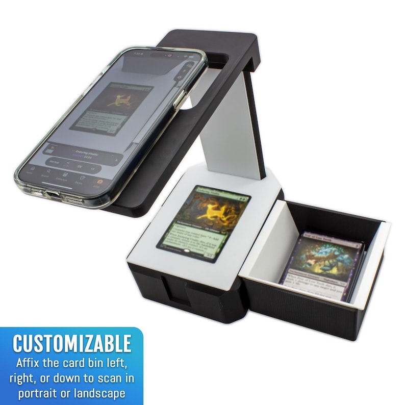 May include: A black and white card scanning device with a smartphone in place. The device has a white platform with a card displayed and a drawer with more cards. The text "CUSTOMIZABLE" is visible, with instructions to affix the card bin.