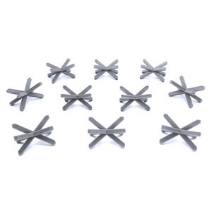 May include: Twelve gray metal anti-tank obstacles, also known as Czech hedgehogs, are arranged in a scattered pattern on a white background.