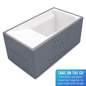 May include: Gray cardboard box with a white foam insert. The box has the text "Scan Stand" and "Evertoys" printed on it. The box is designed to hold a card game and a phone.