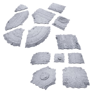 May include: A broken concrete pavement with multiple pieces of concrete broken apart and scattered on a white background.