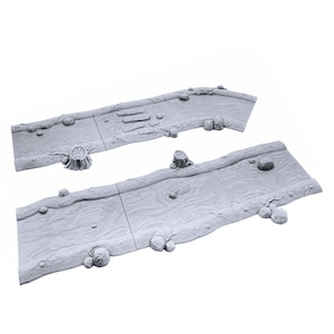 May include: Two grey, textured, rectangular pieces of terrain for tabletop gaming. The pieces are designed to represent a stream or riverbed with raised edges and a textured surface. The pieces are made of a durable material and are suitable for use with miniature figures and other gaming accessories.