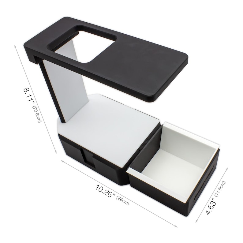 May include: A black and white desk organizer with a drawer. The organizer is 10.26 inches (26 cm) long, 8.11 inches (20.6 cm) high, and 4.63 inches (11.8 cm) wide. The top has a rectangular cutout.