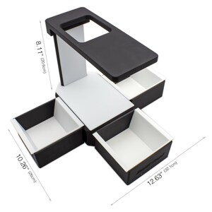 May include: A black and white desk organizer with four drawers and a top shelf. The organizer is 12.63 inches (32.1cm) wide, 10.26 inches (26cm) deep, and 8.11 inches (20.6cm) tall. The drawers and top shelf are black, while the supporting structure is white.