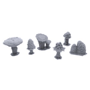 May include: A set of seven gray 3D printed mushroom figurines. The mushrooms are various shapes and sizes, with some having a smooth surface and others having a textured surface.
