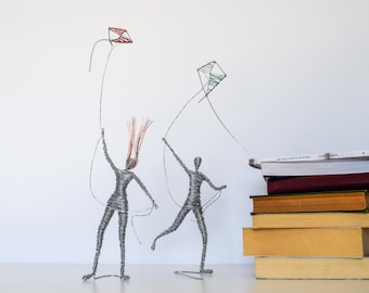Woman sculpture with kite a modern art decoration, wire sculpture with kite.