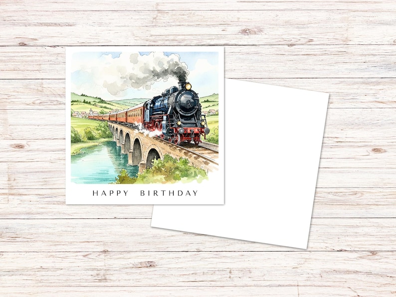 May include: A square greeting card featuring a watercolor illustration of a black steam locomotive pulling red passenger cars across a stone viaduct over a river, with the text HAPPY BIRTHDAY printed in black capital letters at the bottom.