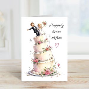 May include: A humorous wedding card featuring a cartoon couple on a precarious, multi-tiered cake adorned with pink roses and pearls. The card displays the words "Happily Ever After" and a small heart.