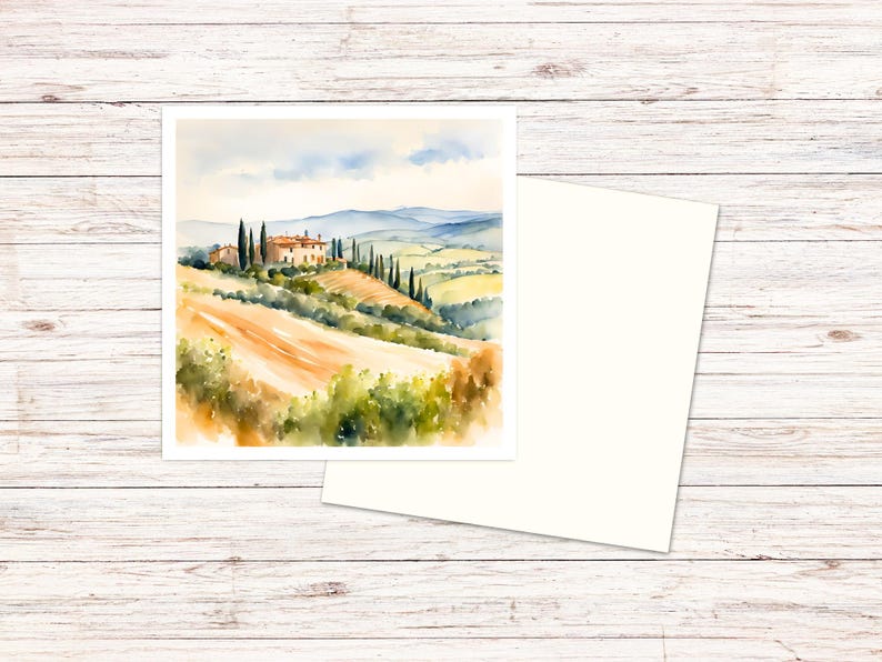 May include: A square greeting card featuring a watercolor painting of a Tuscan landscape with a stone villa, tall cypress trees, and rolling golden hills under a soft blue sky, accompanied by a matching blank white envelope.