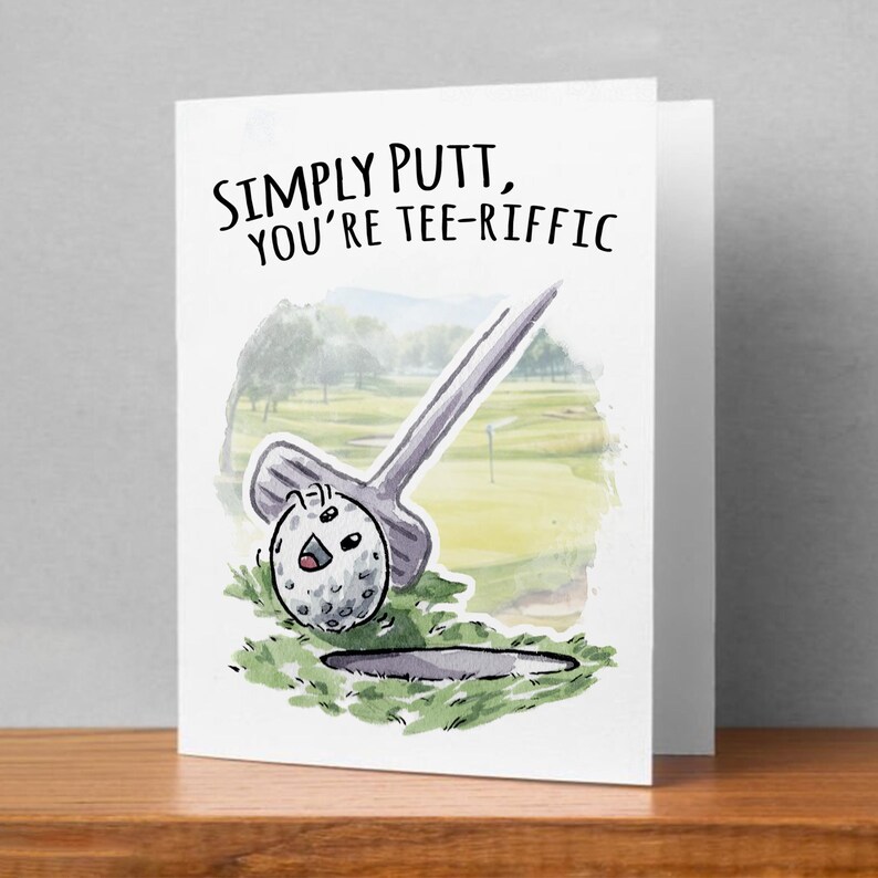 May include: A greeting card with a watercolor illustration of a golf ball and putter on a green golf course. The text on the card reads "Simply putt, you're tee-riffic."