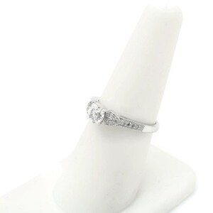 May include: A silver engagement ring with a central diamond and smaller diamonds set in a delicate band.