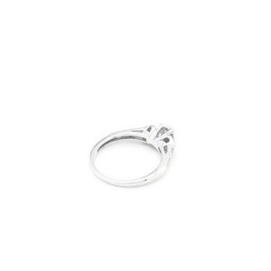 May include: A silver ring with a large, clear center stone and smaller stones on the band.