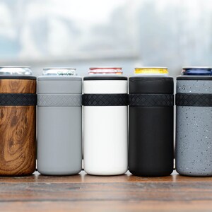 May include: Five insulated can coolers in different colors and patterns. The coolers are made of stainless steel and have a rubber band around the middle. The colors are wood grain, gray, white, black, and speckled gray.