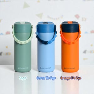 May include: Three insulated water bottles in sage green, light blue, and orange. Each bottle has a matching handle and lid, with the brand name "elemental" printed on the front. The text "Sage", "Ocean Tie Dye", and "Orange Tie Dye" are below each bottle.