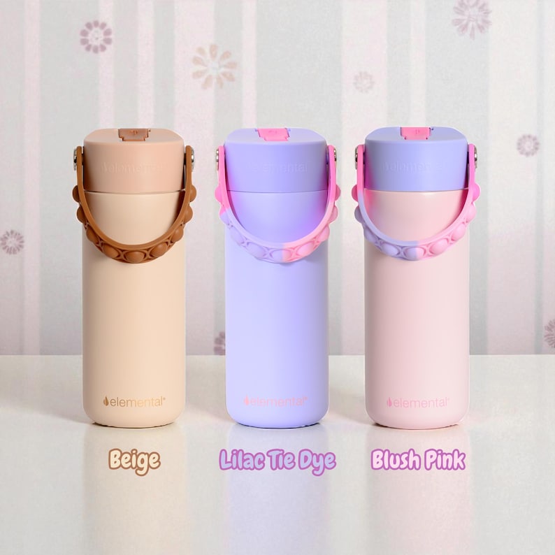 May include: Three insulated water bottles in beige, lilac tie dye, and blush pink. Each bottle has a matching lid and a handle with a bubble design. The text "elemental" is printed on the bottles, and the colors are labeled below.