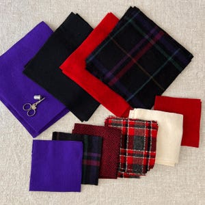 May include: An assortment of colorful fabric squares in various textures and patterns. Colors include purple, black, red, and plaid designs. A pair of small scissors and a thimble are on a purple square.