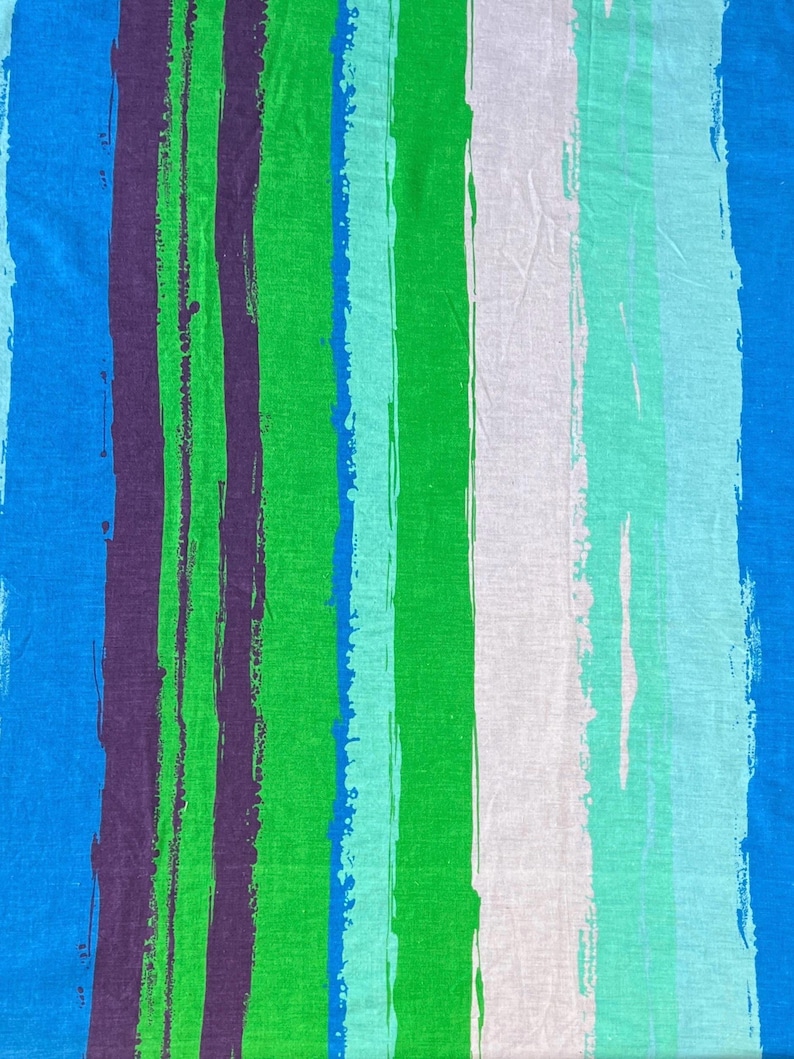 May include: Abstract striped fabric with blue, green, purple, and white brushstrokes. The fabric has a textured, woven appearance.