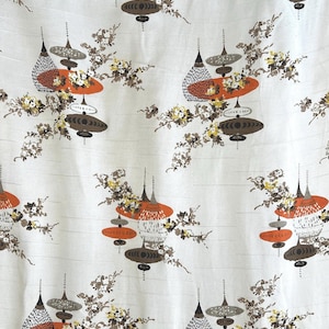 May include: White fabric with a repeating pattern of stylised orange, brown and white ornaments with a floral motif.