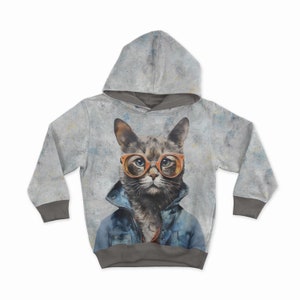 May include: A gray hoodie featuring a cat wearing orange glasses and a denim jacket. The cat's portrait is centered on the front of the hoodie, with a textured gray background and gray cuffs and hood lining.