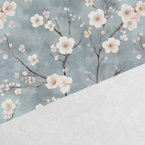 May include: A seamless pattern featuring delicate white cherry blossoms on a light blue background. The blossoms are arranged in a repeating pattern, creating a soft and romantic feel.