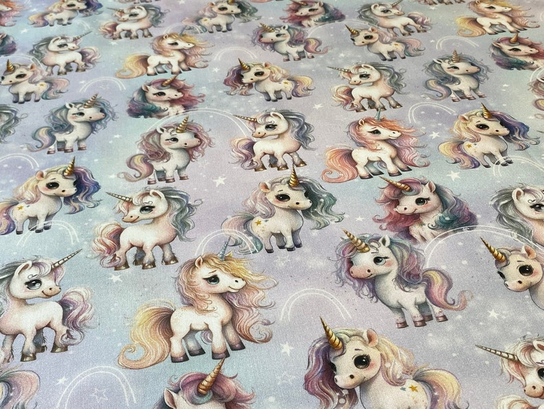 May include: A seamless fabric pattern featuring a repeating design of colorful unicorns with rainbow manes and tails on a light purple background with white stars.
