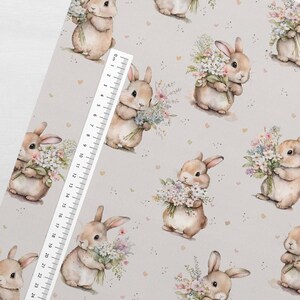 May include: A seamless pattern featuring a repeating design of brown bunnies holding bouquets of pastel flowers on a light gray background with scattered pink hearts.