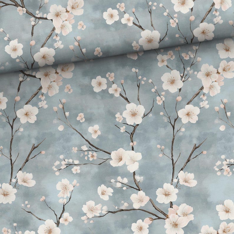 May include: A blue fabric with a white floral pattern. The fabric features a repeating pattern of white flowers with pink centers on a light blue background.