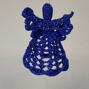 May include: A blue crocheted angel ornament. The angel is made of a delicate, lacy material and has a simple, elegant design.