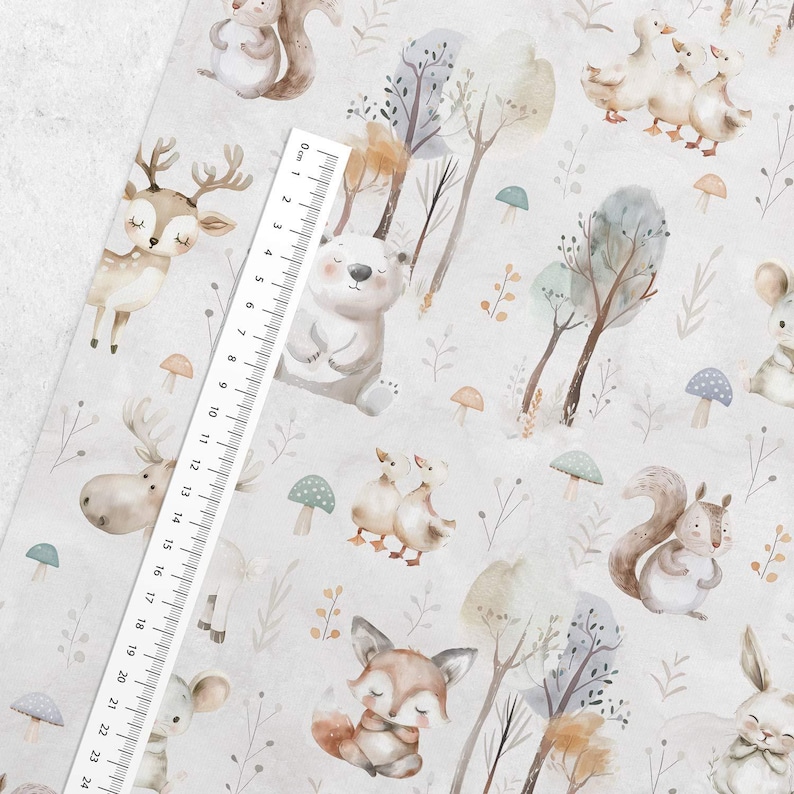 May include: A white fabric with a repeating pattern of watercolor woodland animals, including a deer, a bear, a moose, a fox, a squirrel, and ducks. The fabric also features trees, mushrooms, and leaves.