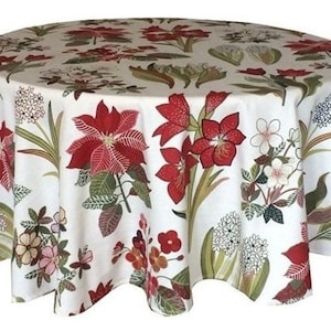 Peut inclure: Une nappe blanche avec un motif floral composé de fleurs rouges, vertes et blanches. La nappe est ronde et a un bord festonné.