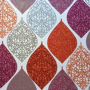 May include: A fabric with a repeating pattern of teardrop-shaped leaves in shades of orange, gray, and pink. The leaves are filled with smaller white leaves.