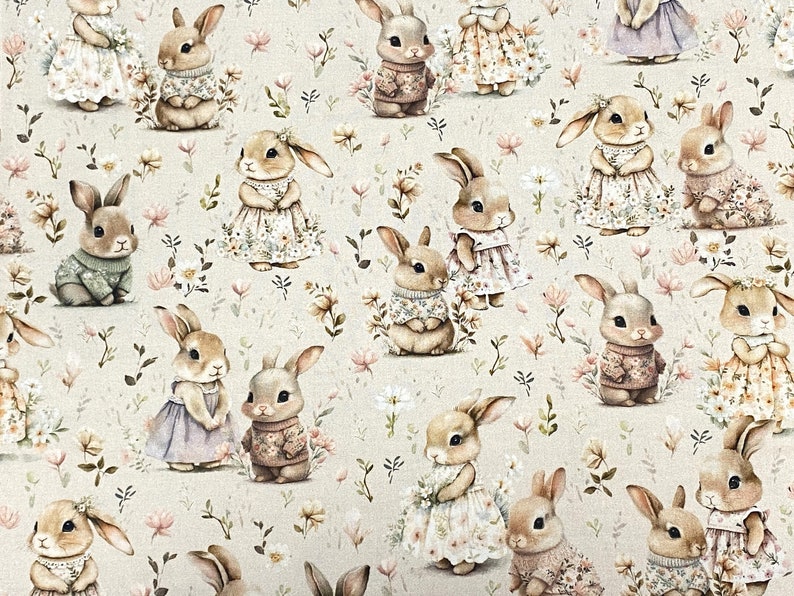 May include: A beige fabric with a repeating pattern of brown rabbits wearing different outfits. The rabbits are surrounded by small pink, white, and green flowers.