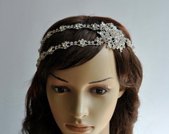 May include: A silver bridal headband with crystal embellishments. The headband has a delicate floral design and is perfect for a wedding or special occasion.