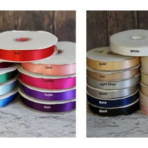 May include: A collection of spools of satin ribbon in various colors, including red, white, green, blue, purple, gold, silver, tan, coral, fuchsia, plum, light blue, light ivory, off white, ivory, nude, blush, and light pink.