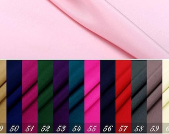 May include: A swatch card with 10 different fabric samples. The samples are arranged in a row from left to right. The colors are: beige, navy blue, magenta, forest green, purple, teal, hot pink, navy blue, red, gray, brown, and cream.