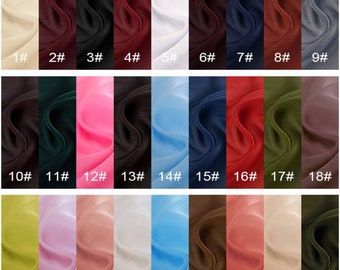 May include: A swatch card with 27 different fabric samples. The samples are arranged in three rows of nine. The fabric samples are in a variety of colors, including beige, red, black, white, pink, blue, green, and brown.