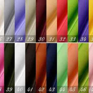 May include: A swatch card with 48 different fabric samples. The swatches are arranged in two rows of 24. The swatches are in a variety of colors, including red, blue, green, yellow, and orange.