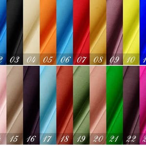 May include: A swatch card with 24 different fabric samples. The swatches are arranged in two rows of 12. The swatches are in a variety of colors, including red, blue, green, yellow, and orange.